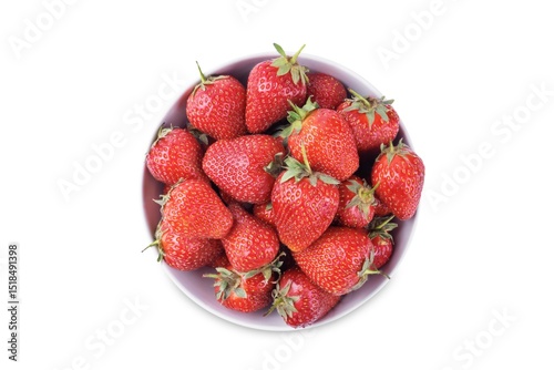 Fresh red strawberries in a white bowl on a white isolated background