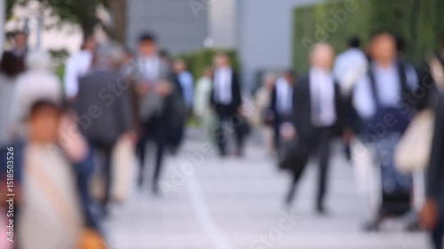 Blurry People Walking on the Sidewalk. Business District. Rush Hour Time. Asian City and Asian People. Blurry Background.