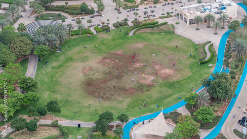 A landscaped public park in Jumeirah Lakes Towers timelapse, a popular residential district in Dubai.