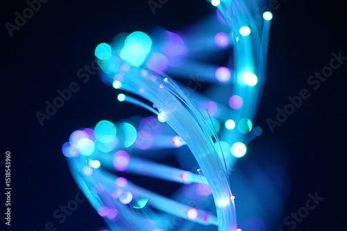 Abstract dna helix fiber optic light strands glowing in blue and purple hues