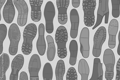 Various types of shoe prints create an artistic pattern on a gray background in a creative display of footwear