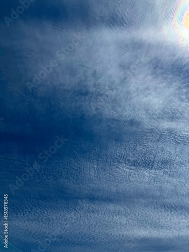 Blue Sky with Wispy Clouds and Subtle Sun Halo Effect