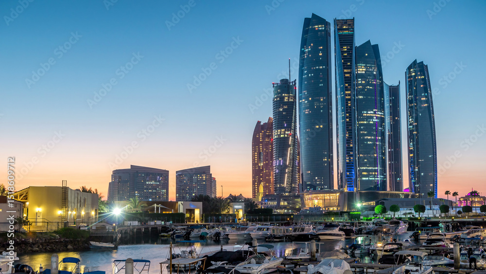 Fototapeta premium Al Bateen marina Abu Dhabi day to night timelapse with modern skyscrapers on background