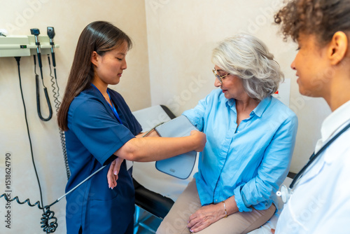 Wallpaper Mural Nurse checking blood pressure of senior woman in medical clinic Torontodigital.ca