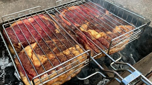 Grilled meat on the grill. Beef steaks are grilled on the grill.