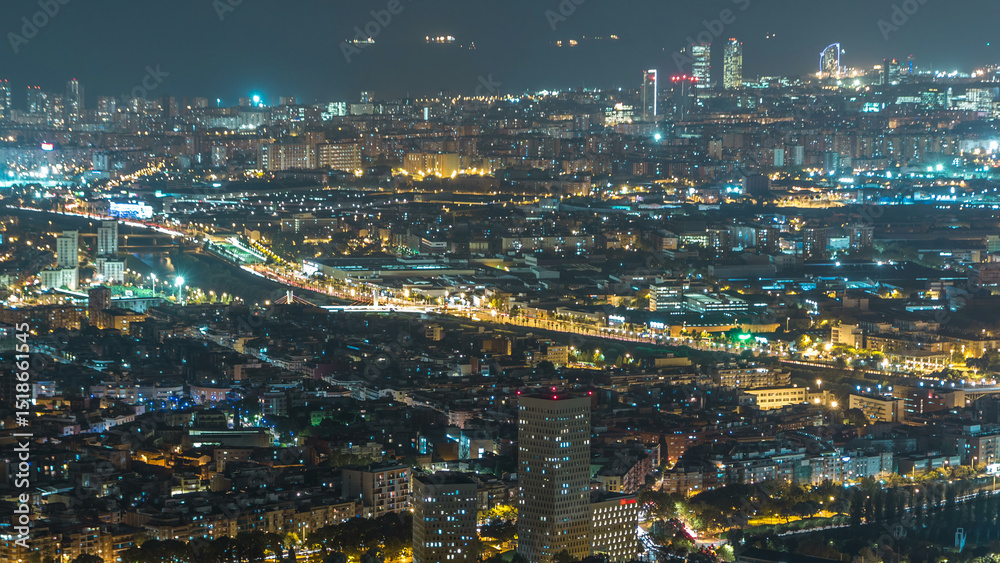 Fototapeta premium Barcelona and Badalona skyline with roofs of houses and sea on the horizon night timelapse