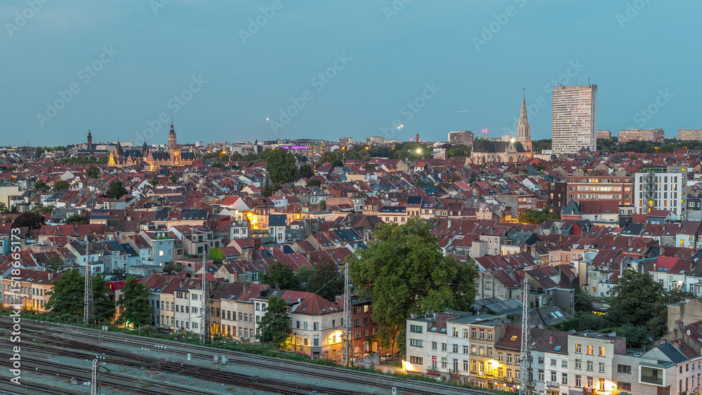 Obraz premium Aerial day to night timelapse panorama over Brussels skyline in Schaerbeek with Saint-Servais Church and Town Hall