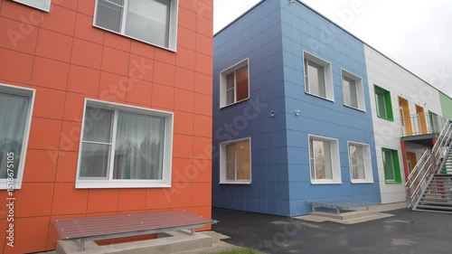 Bright children kindergarten facade appears inviting to explore colorful campus. Playful shapes create environment inspiring for adventures