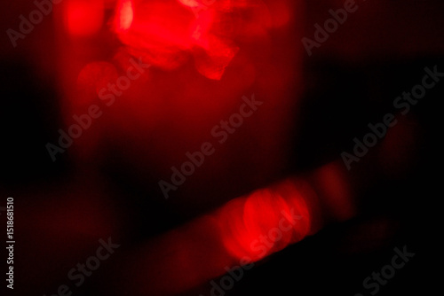 Abstract red lens flare effect on black background for design. Random color and light shapes.