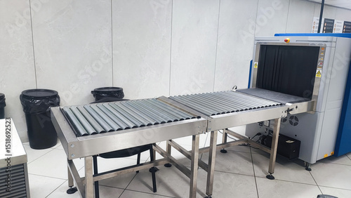 Security Checkpoint in Airport Terminal: Suitcases and Bags of Passengers Moving on Conveyor Belt Inside Advanced Metal Detector X-ray Scanner. Baggage Screening Procedure for Boarding Plane Flight.
