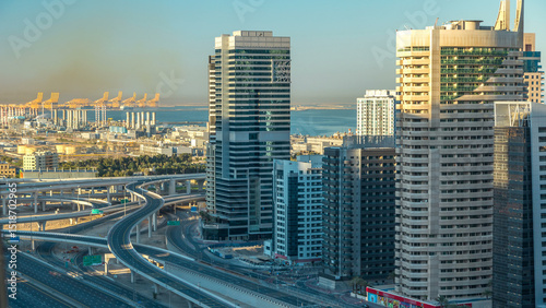 Dubai Marina skyscrapers aerial top view at sunrise from JLT in Dubai timelapse, UAE.