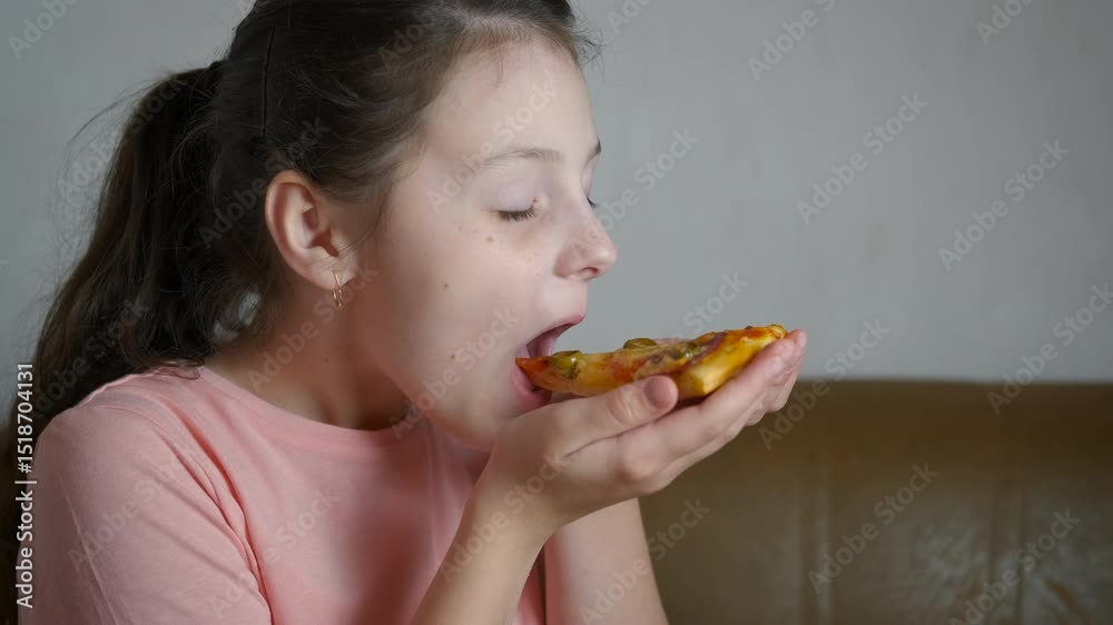 Child taste italian pizza in kitchen. A little girl enjoy the taste of italian pizza in the kitchen. A concept of children enjoy unhealthy food. Child taste italian pizza in kitchen. A little girl enjoy the taste of italian pizza in the kitchen. A concept of children enjoy unhealthy food.