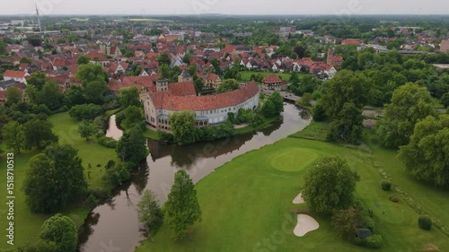 A panoramic drone view of the city and the castle, which sits on the water, in Steinfurt, Germany (Wasserschloss Burgsteinfurt)