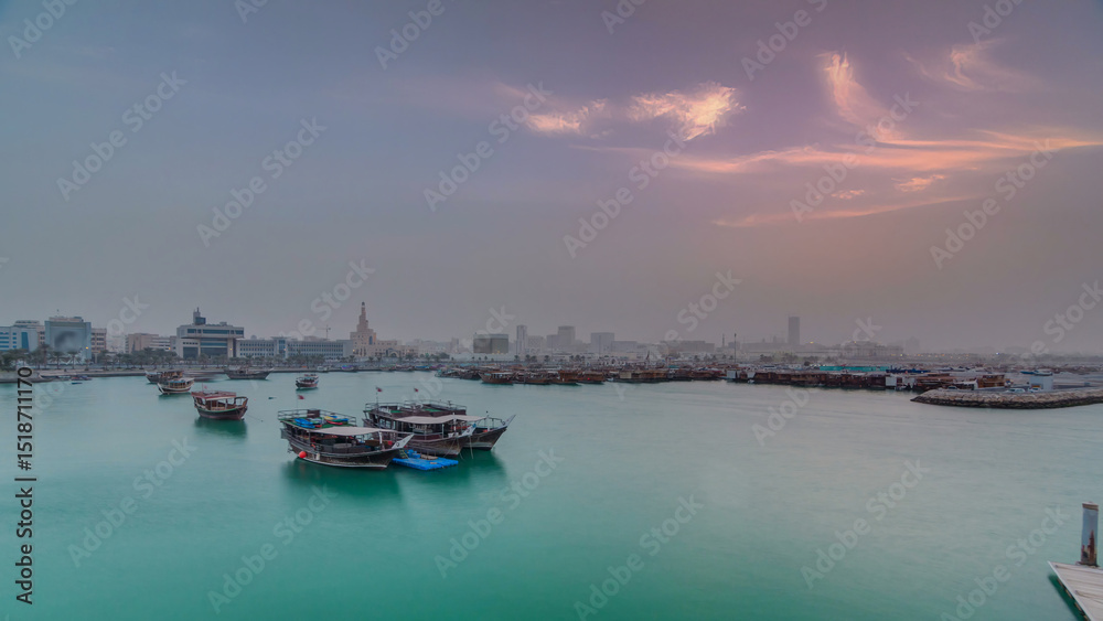 Fototapeta premium Sunset at Doha Bay timelapse with Traditional Wooden Dhow Fishing Boats.