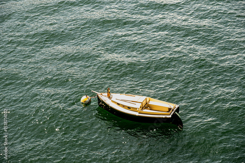 Fototapeta Naklejka Na Ścianę i Meble -  Small boat on the lake waters, Lago di Como, Italy