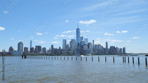 New York City, USA - May 21, 2025: Iconic Manhattan’s view across the Hudson River under blue skies.