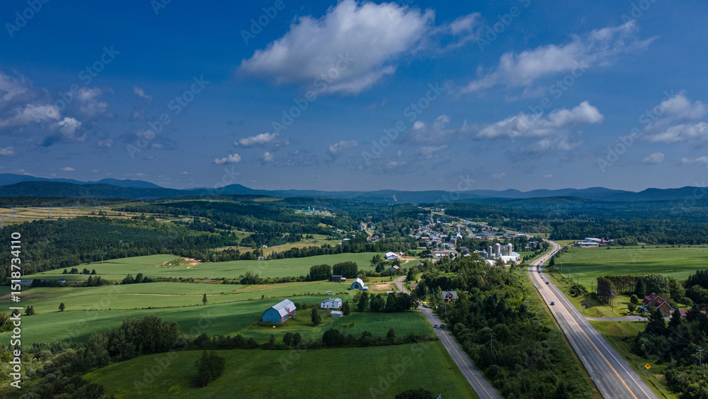 Fototapeta premium Aerial view of a small rural village on a beautiful summer day
