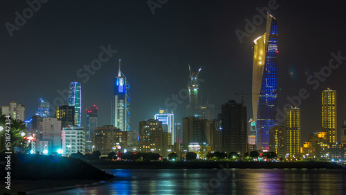 Skyline with Skyscrapers night timelapse in Kuwait City downtown illuminated at dusk. Kuwait City, Middle East