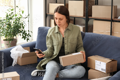 Young woman with parcel usi...