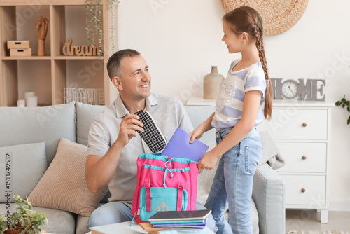 Father helping his little d...