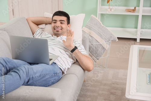 Young man with laptop video...