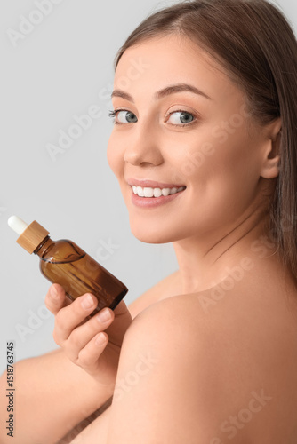 Beautiful woman with serum ...