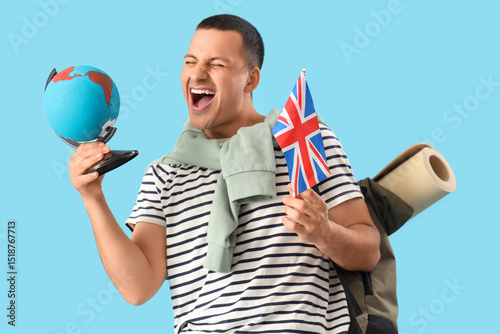 Happy male tourist with glo...