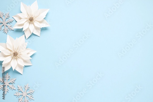 white poinsetti on a blue background with snowflakes