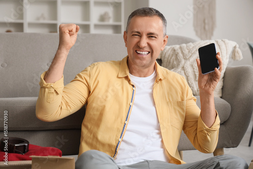 Happy mature man with blank...