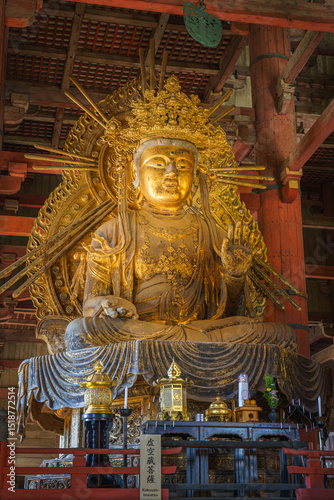 Nara, Japan - Sep 26 2024, vertical, Panoramic view of the gilded giant Buddha statue in Todaiji Temple, hall of Grand sitting Buddha Vairochana, without people, Nara, Japan photo
