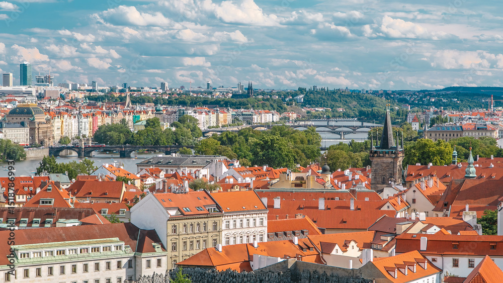 Fototapeta premium Panorama of Prague Old Town with red roofs timelapse, famous bridges and Vltava river, Czech Republic.