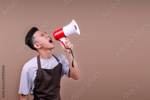 Energetic Barista Guy Wearing Brown Apron Yelling Through Bullhorn Calling Out To The Side