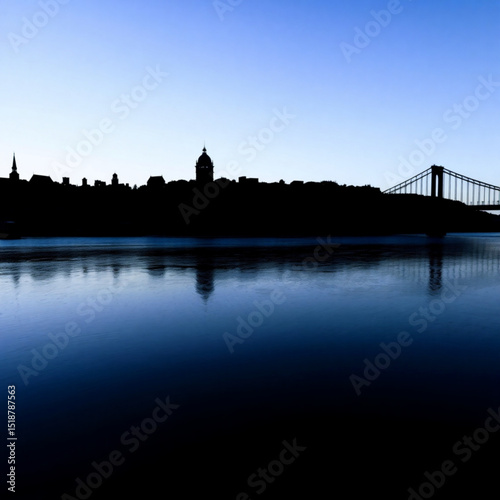 Silhouette of city skyline with bridge over water at dusk scenic landscape photography image for travel