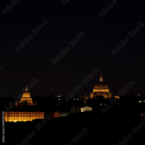 Nighttime cityscape photography featuring illuminated buildings and dark skies in urban landscape setting