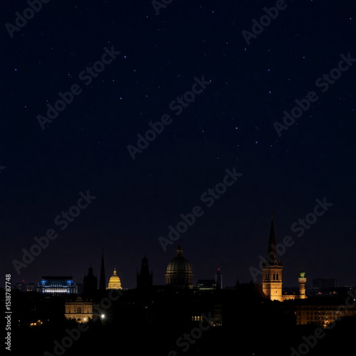 Night cityscape skyline photography featuring stars and illuminated buildings in the dark sky view