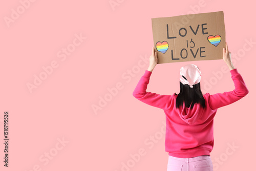 Young woman holding placard...