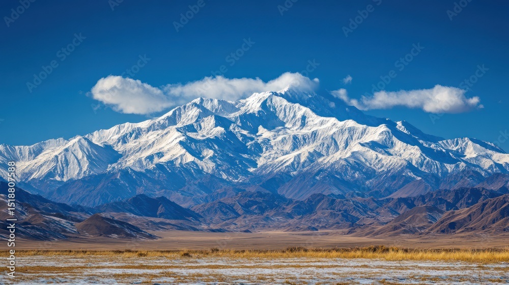 Fototapeta premium Majestic Snow-Capped Mountain Range Under a Clear Blue Sky
