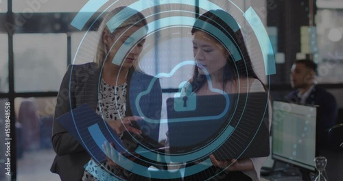 coworkers reviewing folder  and  laptop initiating security rings cloud lock icon for data protectio