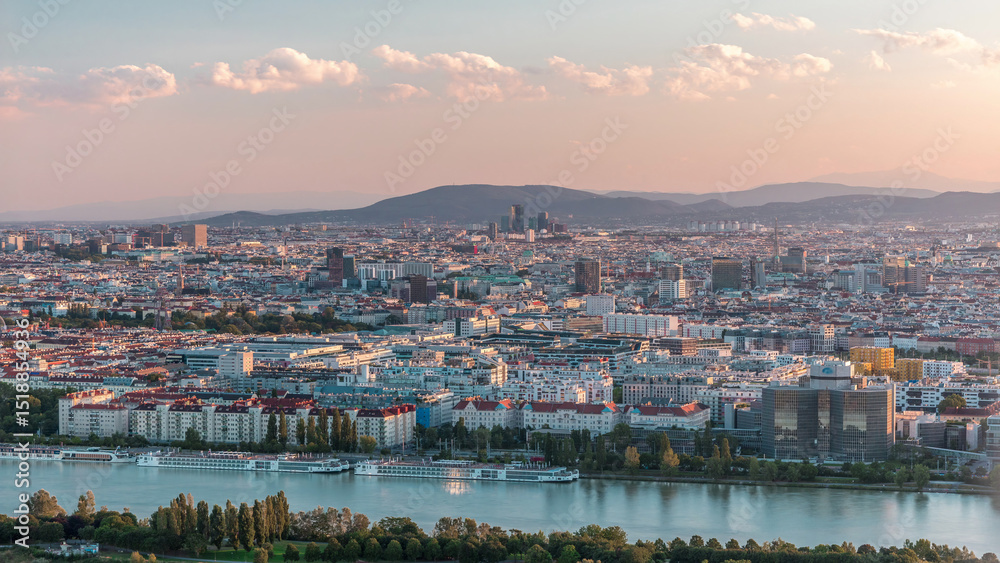 Obraz premium Aerial panoramic view of Vienna city with skyscrapers, historic buildings and a riverside promenade timelapse in Austria.