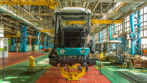 Conveyor assembly stage the body of tractor at big industrial factory timelapse