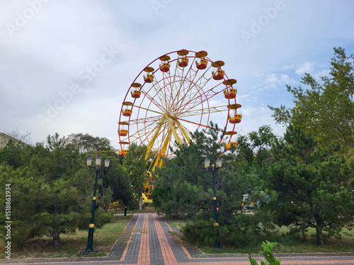 Ferris wheel surrounded by trees in Kerch.