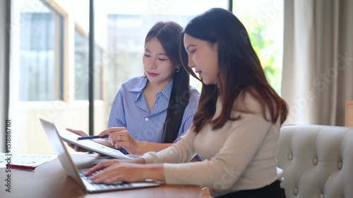 Effective adult asian businesswomen collaboration using laptop and tablet to manage diverse projects a dynamic scene of an asian businesswomen collaboration achieving great results.