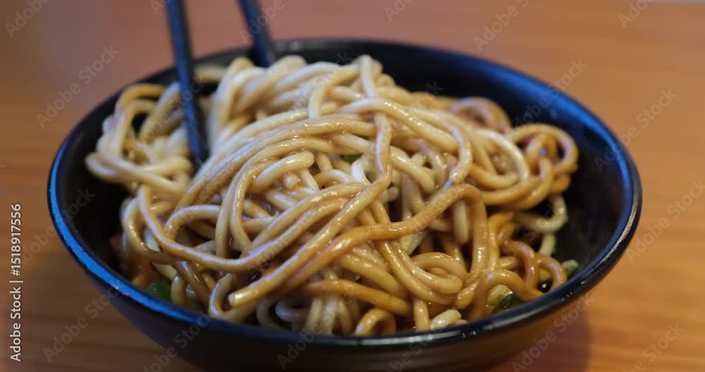 stir hot dry noodles with chopsticks, food in Wuhan, China stir hot dry noodles with chopsticks, food in Wuhan, China