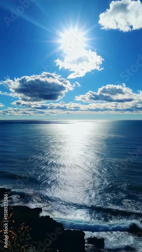 Serene Coastal Scene Bright Sun, Blue Ocean, and Cloudscape