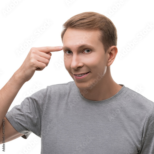 Man gestures to his head with a smile in a bright, simple setting
