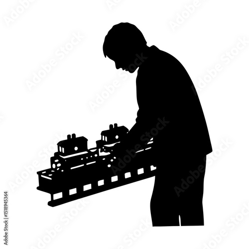 Man playing with a miniature train set silhouette
