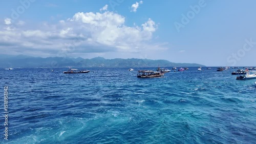 boats anchored in open ocean near a picturesque pier, capturing the tranquility of maritime life and vast blue horizon and mountanes , Indonesia