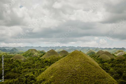 Beautiful landscape of the UNESCO's World Heritage of the Chocolate Hills in the Philippine province of Bohol outdoor at daytime during a cloudy day at the end of April in South East Asia.