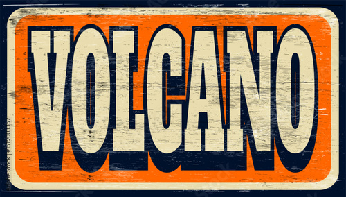 Aged and worn volcano sign on wood