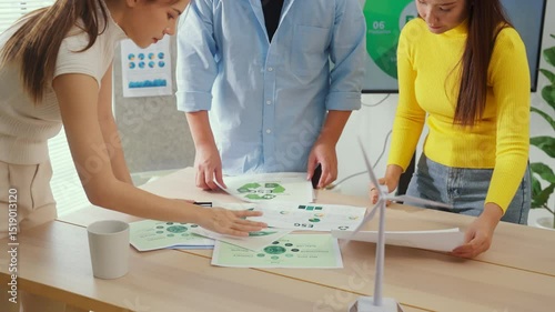 A group of business professionals stands in a modern corporate office, actively engaged in an ESG-focused brainstorming session, analyzing convergent strategies with agile planning methods 